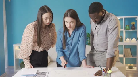 A multiethnic group of friends is working on the architectural project. Stock Footage 228804738