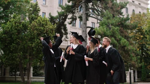 Multiethnic group of graduates students after the graduation in the college park Stock Footage 180622380