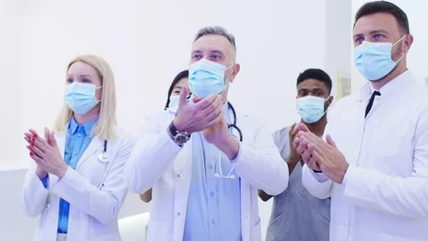 Multiethnic group of happy proud doctors clapping with hands after successful 動画素材 227205143