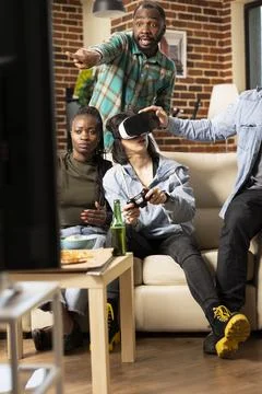 Multiethnic group having fun at home with 3d gaming Stock Photos
