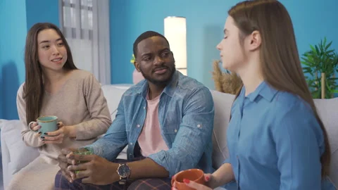 Multiethnic group at home, chatting. 動画素材 228801986
