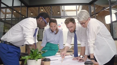 Multiethnic group of lawyers work with startup project at desk in lighting room. Stock Footage 94772025