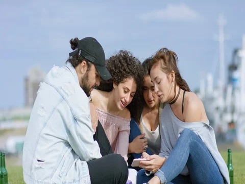 Multiethnic group outside is looking at smartphone Stock Footage 81015135