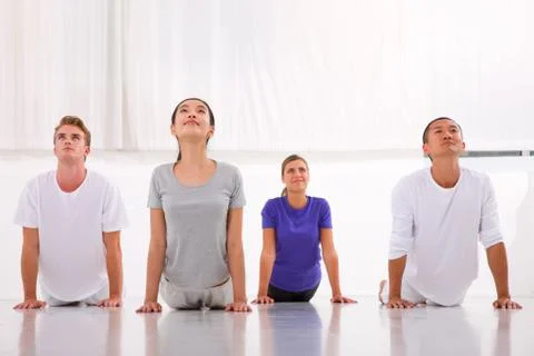 Multiethnic group of people practicing yoga Stock Photos
