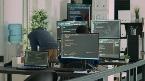 Multiethnic group of programers working on server code to develop new database Stock Footage 222023359