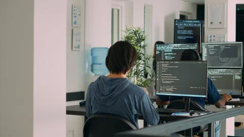Multiethnic group of programers working on server code to develop new database 库存照片