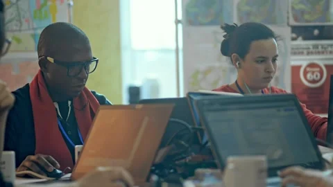 Multiethnic group of students are working with laptops at table in university Stock Footage 135811499