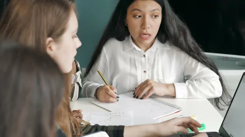 Multiethnic group talk looking at computer do online research project assignment Stock Footage 143252230