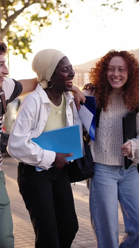 Multiethnic group of young cheerful students walking and talking outdoors. Stock Footage 270185554