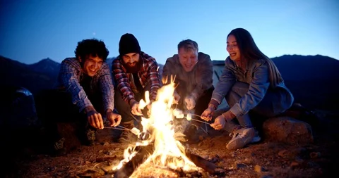 Multiethnic hipster students having fun on a trip. Group of friends sitting near Stock-Footage 129339592