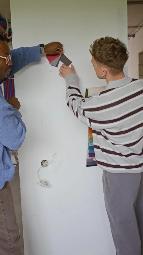 Multiethnic Interior Designers Selecting Paint Swatches for Home Renovation Stock Footage 340627331