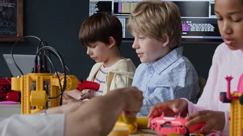 Multiethnic Kids Assembling Robots during Class with Teacher in School Stock Footage 339201090