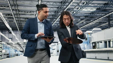 Multiethnic management executives use device to examine semiconductor substrate Stock Footage 333392703