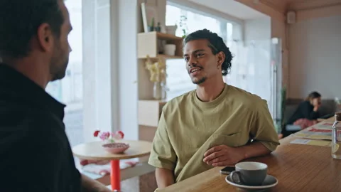 Multiethnic men flirting cafe close up. Two relaxed guys talking in cafeteria Stock Footage 248312722