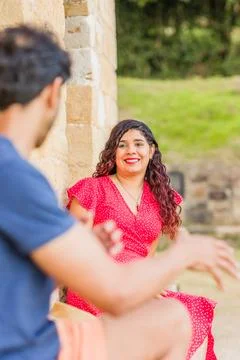 Multiethnic middle aged couple talking and laughing happy conversation Stock Photos