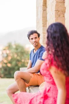 Multiethnic middle aged couple talking and laughing happy conversation Stock Photos