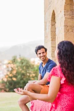 Multiethnic middle aged couple talking and laughing happy conversation Stock Photos