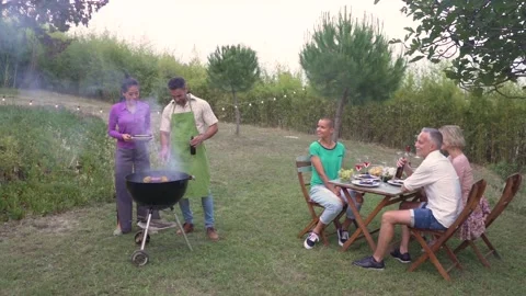 Multiethnic middle-aged people cooking the barbecue smiling happy and laughing Video stock 220807419
