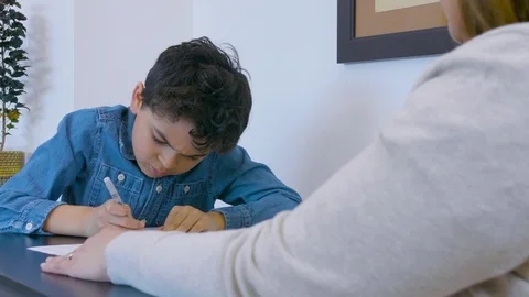 Multiethnic mother and son doing homework 6 Stock Footage 89352034