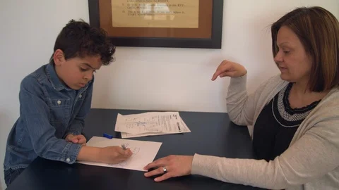 Multiethnic mother and son doing homework 4 Stock Footage 89358363