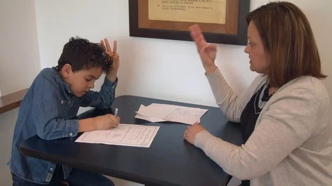 Multiethnic mother and son doing homework 2 Stock Footage 89358381