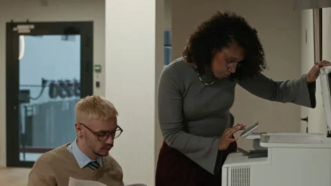 Multiethnic Office Workers Copying Documents on Scanner at Workplace Stock Footage 309038360