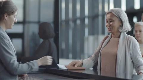 Multiethnic Passengers Checking In at Registration Counter at Airport Stock Footage 123212660