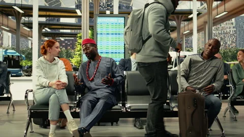 Multiethnic passengers waiting on their long-haul coach in busy bus station Stock Footage 334724466