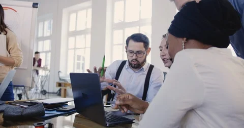 Multiethnic professional software developers work together with laptop at loft Stock Footage 108164847