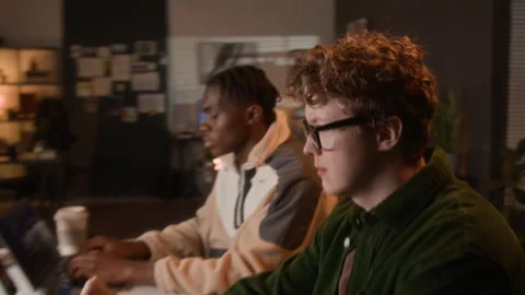 Multiethnic Programmers Coding on Laptops in Office at Night Stock-Footage 336710775