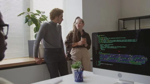 Multiethnic Programmers Talking at Coffee Break in Office Video stock 255783119