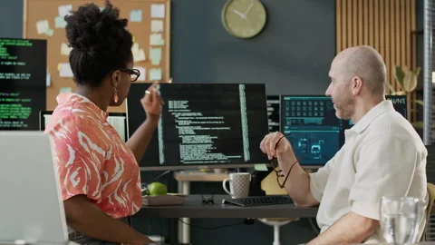 Multiethnic Programmers Talking while Coworking in Open Space Office Stock Footage 306840991