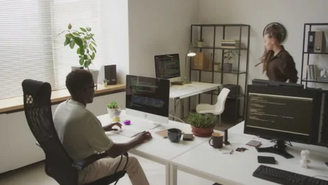 Multiethnic Programmers Working in Open Space Office Stock Footage 255780948