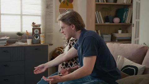 Multiethnic Roommates Arguing over Television Remote Control on Couch Stock Footage 336621945