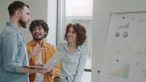 Multiethnic sales staff in the office. is having a monthly summary meeting to Stock Footage 237163779