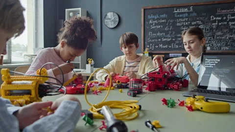Multiethnic Schoolchildren Constructing Robots in Stem Class Stock Footage 339197390