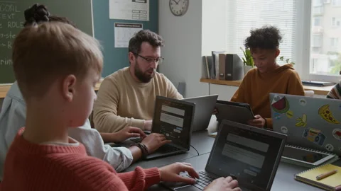 Multiethnic Schoolchildren Practicing in Writing AI Prompts at Lesson Stock Footage 318720579