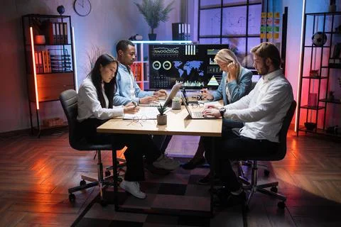 Multiethnic software developers using gadgets for work at office 스톡 사진