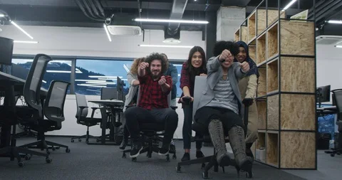 Multiethnic startup team of software developers having fun while racing on of Stock Footage 114100203