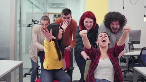 Multiethnic startup team of software developers having fun while racing on of Stock Footage 146962555