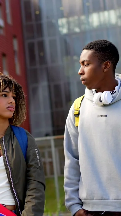 Multiethnic students chatting and using mobile walking out the university Stock Footage 285117513