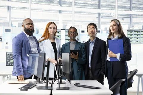 Multiethnic team brainstorming in semiconductor manufacturing research facility Stock Photos