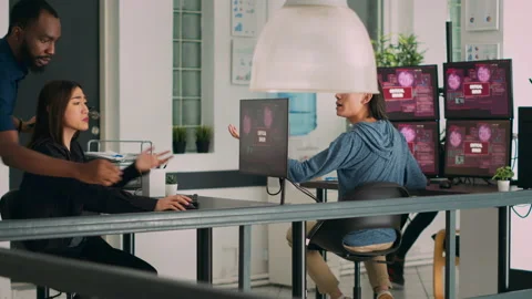 Multiethnic team of coders encountering system error message on computer Stock Footage 227618500