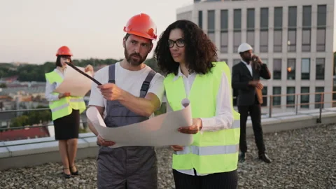 Multiethnic team of developers examining architectural plan Stock Footage 246128095