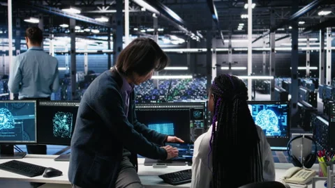 Multiethnic team in diverse data center coding with generative AI assistance Stock Footage 313640454