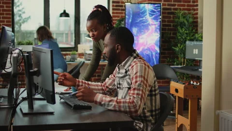 Multiethnic team of employees talking about engine component Stock Footage 232074597