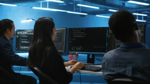Multiethnic team of engineers working in high tech server hub, Stock Photos