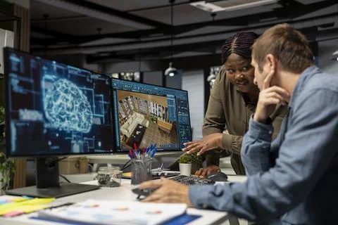 Multiethnic team of experts using artificial intelligence to design a floor plan 写真素材