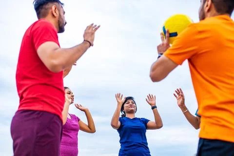 Multiethnic team group playing beach volley on sun light Stock Photos