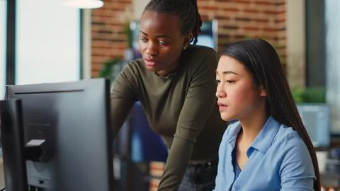 Multiethnic team of IT developers working on computers Foto stock